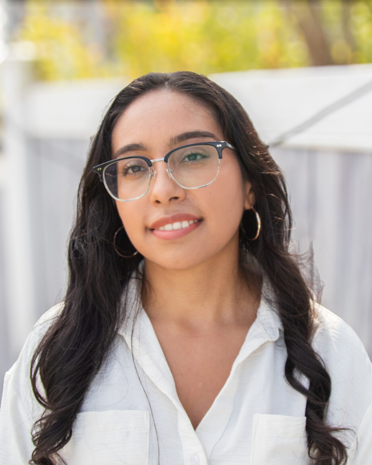 A portrait photo of me with a fall leaves in the background